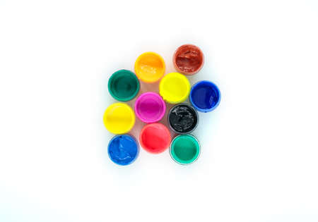 jars of colorful paint with open lids, top view close up, isolated object