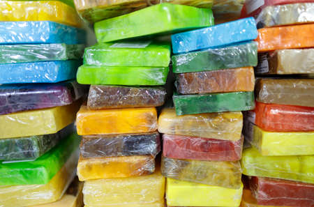 multicolored soap wrapped in cellophane lies togetherの写真素材