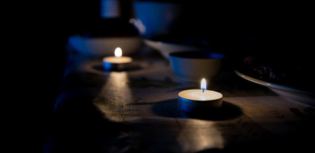 candle is burning on the table, dark, festive dinner