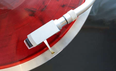 tonearm cartridge close up on red vinyl background, top viewの写真素材