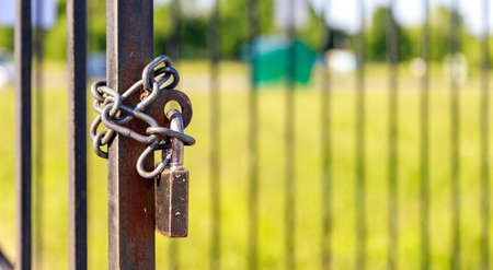 metal chain and lock hang on the metal doorの写真素材