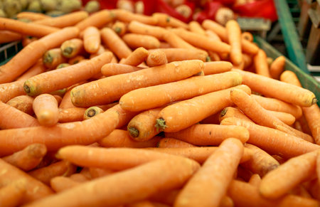 a lot of washed carrots are on the counter of the storeの写真素材