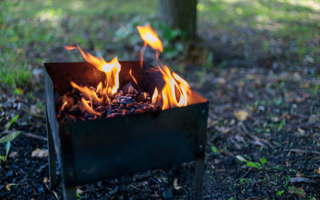 the fire is burning in the grill, you can see hot coalの写真素材