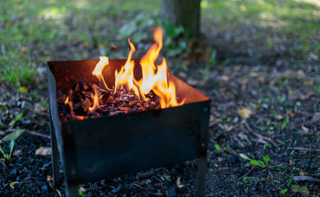 the fire is burning in the grill, you can see hot coalの写真素材