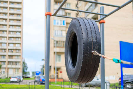 black car tire hanging on the playgroundの写真素材