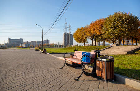 blue package on a bench against the background of the urban landscape and trees, power linesの写真素材
