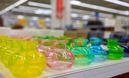 multicolored glass bottles stand on the counter of the storeの写真素材