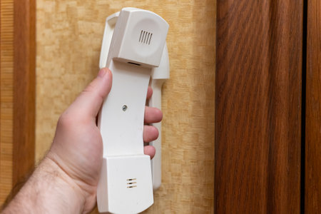 man answers the call to the intercom, close-up of the intercomの写真素材