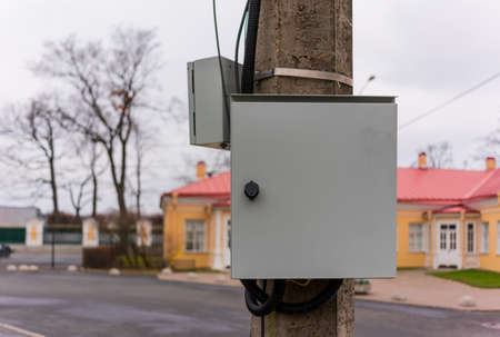 metal junction box hanging on a poleの写真素材