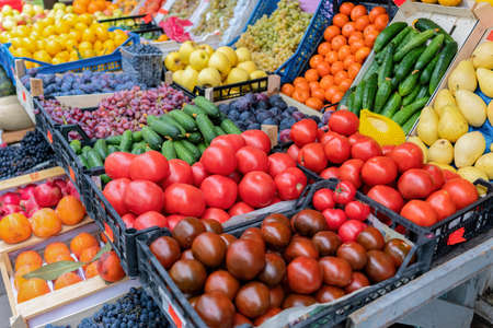 Fresh raw vegetables in boxes on a street market close-upの写真素材