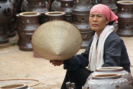 Hanoi, Vietnam, August 19, 2008 - Vietnamese woman with hatのeditorial素材