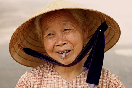 Hoi An, Vietnam, August 21, 2008 - Cigarette Woman in Vietnam