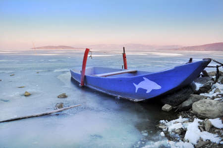 Boat on frozen Trasimeno lake, Italyのeditorial素材