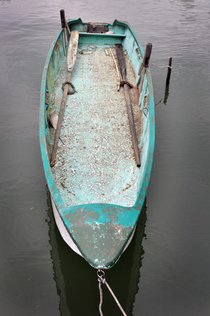 front of a old blue painted fishing boat in the harborの写真素材