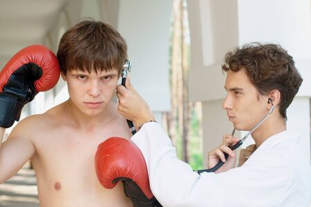 Funny photo of a doctor cheking a stupid and angry boxer