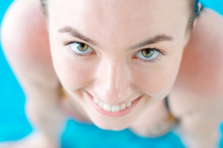 Smiling young girl at the swimming poolの写真素材