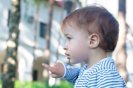 Baby pointing at the park (with copy space)の写真素材