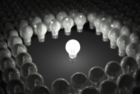 Single lit light bulb stading out in a crowd.の写真素材
