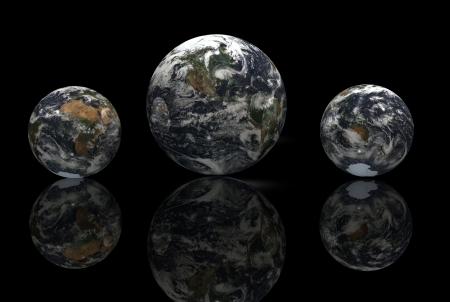 Earth from space as a marble reflected against black.