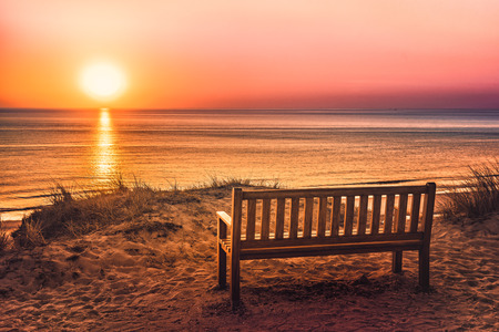 Empty bench at sunset on the island of Syltの写真素材