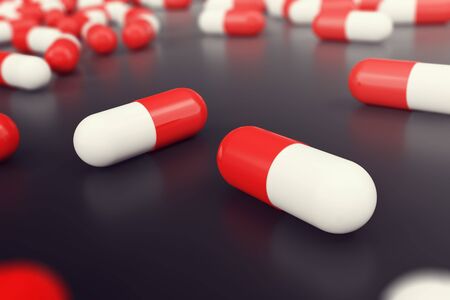 Heap of red white round capsule pills with medicine antibiotic in packages on black background, 3d illustrationの写真素材