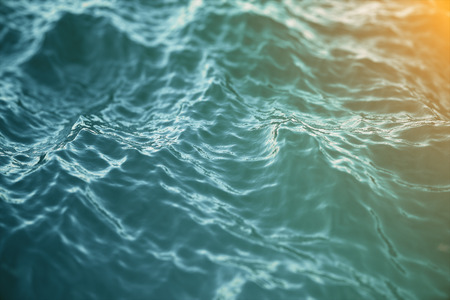 Blue water background with ripples, sea, ocean wave low angle view. Close-up Nature background. Soft focus with selective focus, 3d renderingの写真素材