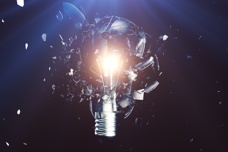 Exploding light bulb on a blue background, with concept creative thinking and innovative solutions. 3D renderingの写真素材