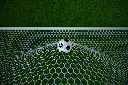 3d rendering soccer ball in goal. Soccer ball in net with spotlight and stadium light background, Success concept. Soccer with green grassの写真素材