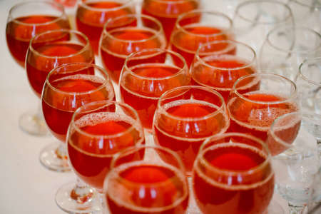 Glasses of red wine on a table in a restaurant, close-upの写真素材