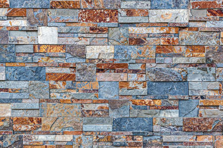 A wall made up of medium to large colored stones in a detailed view of the surface structure. Detailed view in excellent quality. For your graphic projectsの写真素材