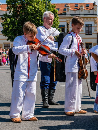 Straznice, Czech Republic - June 25, 2022 International Folklore Festival. Children in folk costumes play the violinのeditorial素材