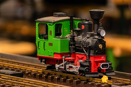 Brno Czech Republic - June 4, 2021 A small model of a green steam locomotive on the tracks