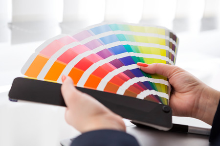 Graphic designer working with pantone palette in studioの写真素材