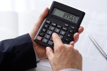 Men s hands with calculatorの写真素材