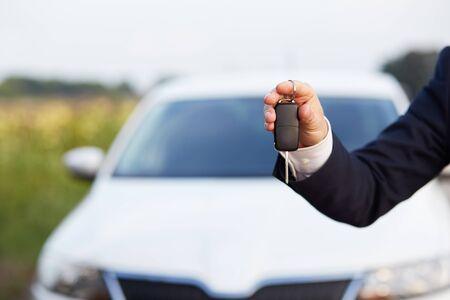 Man in a suit holding car keysの写真素材