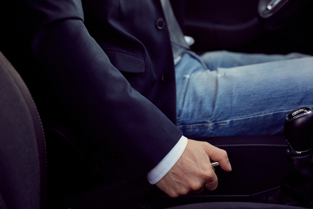 Close up of driver pulling handbrake lever in carの写真素材