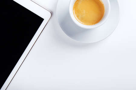 Top view of workplace, tablet with coffee on white tabletの写真素材