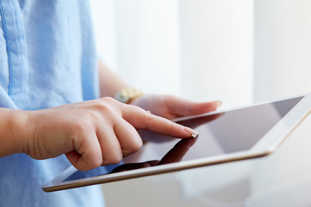 Woman touching digital tablet, view close up