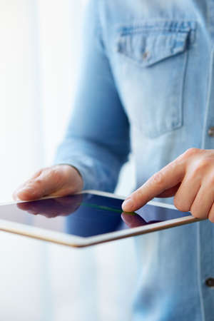 Man holding white digital tablet, view close up