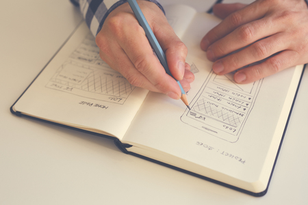 Close up of man sketching graphic sketch in office. Tonedの写真素材