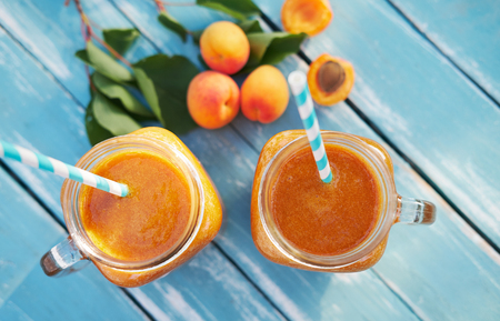 Top view of two glasses of fresh apricot smoothieの写真素材