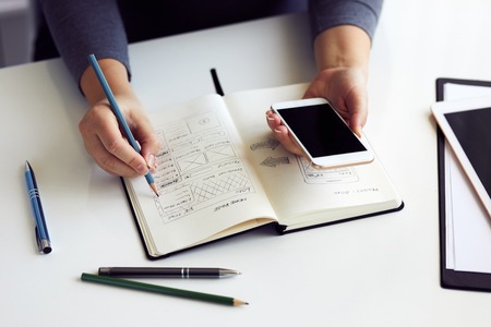 Close up of woman sketching graphic sketch in officeの写真素材