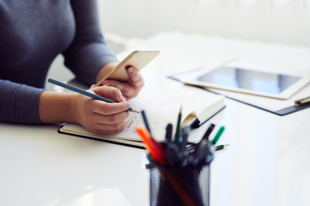 Woman sketching graphic design in his diary for new websiteの写真素材