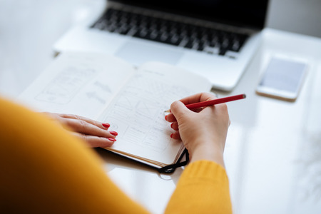 Woman sketching new design for a website in the office