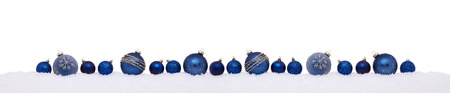 Blue christmas balls in a row isolated on snow, Christmas bannerの写真素材