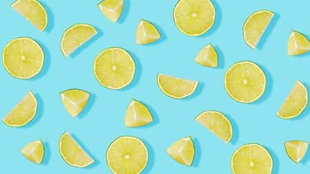 Top view of fruit pattern from pieces of lime on blue backgroundの写真素材