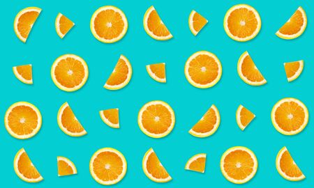 Top view of fruit pattern from slices of orange on blue backgroundの写真素材