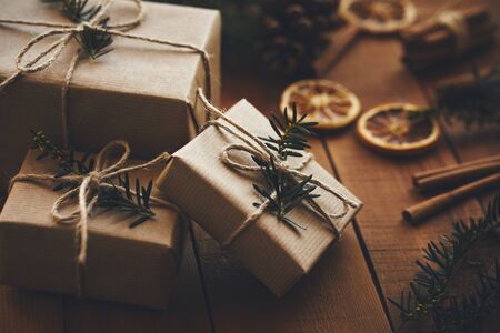 Three Christmas gifts on wooden boards with decorationの写真素材