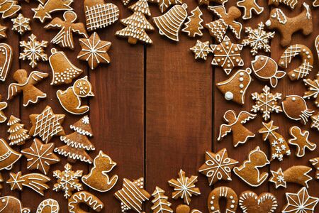 Flat lay Christmas wooden background with gingerbreads and copy spaceの写真素材