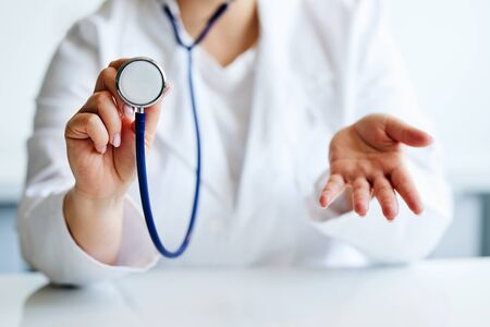 Female doctor with stethoscope doing surprise gestureの写真素材